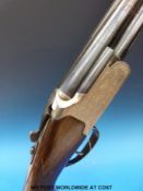 Lanber 12 bore over and under multi-choke ejector shotgun with ornate engraving of snipe,