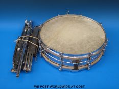 An Olympic snare drum and stand together with two music stands