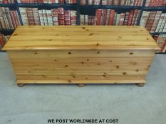 A pine blanket box raised on bun feet (L136 x D43 x H50cm)