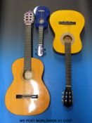 Two nylon stringed acoustic guitars comprising a three-quarter 