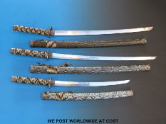 A graduated set of Samurai swords in ornate snakeskin scabbards; the blades 43cm,