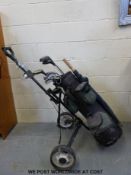 Two sets of golf clubs with trolleys