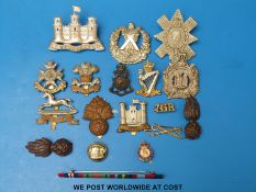 A quantity of military badges, including Cameron, King's Own Scottish Borderers etc,