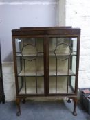 A glazed display cabinet with octagon motifs to doors (W89 x D34 x H132cm)
