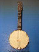 A cased British made ukelele banjo with chased resonator metal back