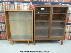 Two glazed display/bookcases, one with ministry broad arrow to rear.