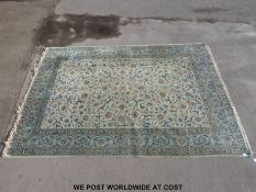 A large wool Kashan rug with blue ground decoration