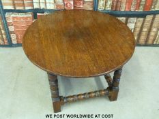 An oak circular coffee table.