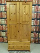 A pine wardrobe with two drawers below (W90 x D 58 x H188cm)