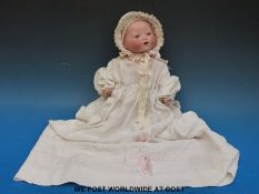 An Armand Marseille bisque headed doll with open mouth and weighted brown eyes,