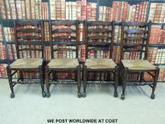 Four rush-seated oak ladder back chairs