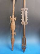 Two carved tribal paddles