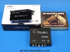 Pro-Ject phono box together with an HDMI 3D switch and His Master's Voice tin with cassette