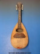 A mandolin by G Grandini with inlaid rosewood back,