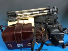 A collection of camera equipment including cased Olympus OM10, spare lenses,