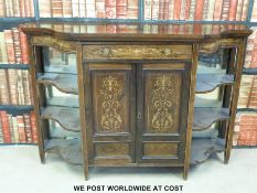 A Victorian rosewood credenza with central drawer and cupboards flanked by shelves (W138 x D40 x