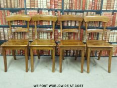 A set of four solid seat dining chairs