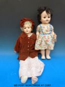 An unmarked bisque headed doll with open mouth and fixed brown eyes.