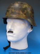 A Nazi German WWII helmet stamped ET66 to inside of rim