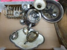 A collection of silver plate including trays, candlesticks, teapot, toastrack,