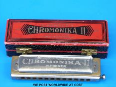A cased chromatic harmonica by M Hohner in key of C
