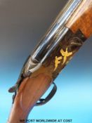 A Winchester Select Midnight 12 bore over and under ejector shotgun with gold inlay in the form of