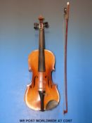 A 20thC cased anonymous violin with 33.5cm flame back, complete with bow and case.
