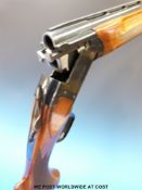 Remington 3200 12 bore over and under shotgun with engraving of dogs to the locks,