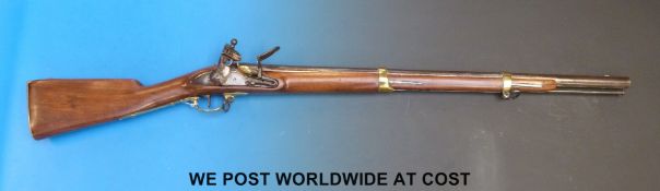 An India Pattern 'Brown Bess' two band flintlock musket with brass pan,