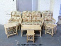 A cane conservatory suite comprising sofa, two chairs,
