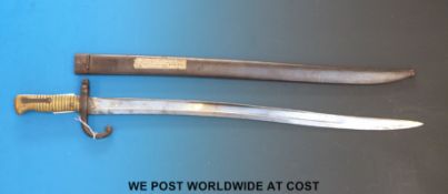 A French 1874 pattern engraved bayonet in metal scabbard