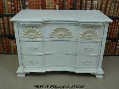 A painted breakfront chest of three drawers (width 107cm) and a wicker coffee table with glass top