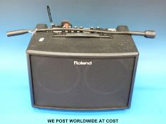 A Roland Acoustic Chorus AC-60 amplifier in soft carry case.