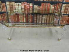 A modern coffee table with gilt and perspex base (70 x 130 x 76cm)