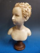 An early 20thC wax bust of a young lady mounted on wooden base (15in tall)