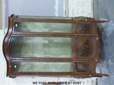 A 19thC French walnut serpentine gilt mounted display cabinet with romantic scenes to lower panels