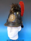 An early 20thC unidentified Belgian helmet of leather construction with red plume and fur comb to