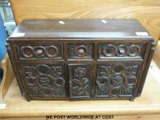 An oak carved miniature or apprentice chest/ sideboard with columns to corners,