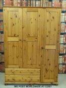 A pine wardrobe with hanging spaces and drawers (W133 x D57 x H188cm)