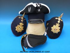 A collection of military and other style hats including pith helmet,