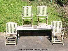 A rectangular teak garden table and four chairs