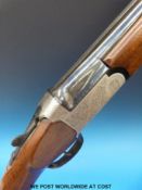 Lincoln 12 bore over and under shotgun with all over floral engraving, double trigger,