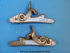 A pair of John Manton & Co hammer action lock mechanisms with ornate scrolling engraved decoration