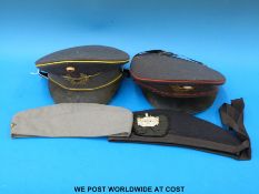 Four military type items of head gear, including East German caps,