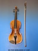 A late 19th/early 20thC Stradivarius copy violin with 36cm back and bow in case.