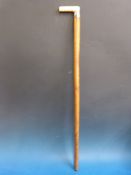 A marine ivory-handled walking stick with white metal collar marked 