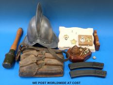 A quantity of militaria to include magazine pouch, replica stick grenade, replica helmet,
