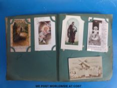 An Edwardian postcard album with additional loose cards including Gloucester street scenes, trams,