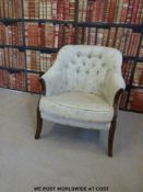 A mahogany button backed upholstered chair with floral material