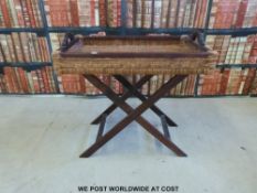 A wicker tray-topped table or butler's tray